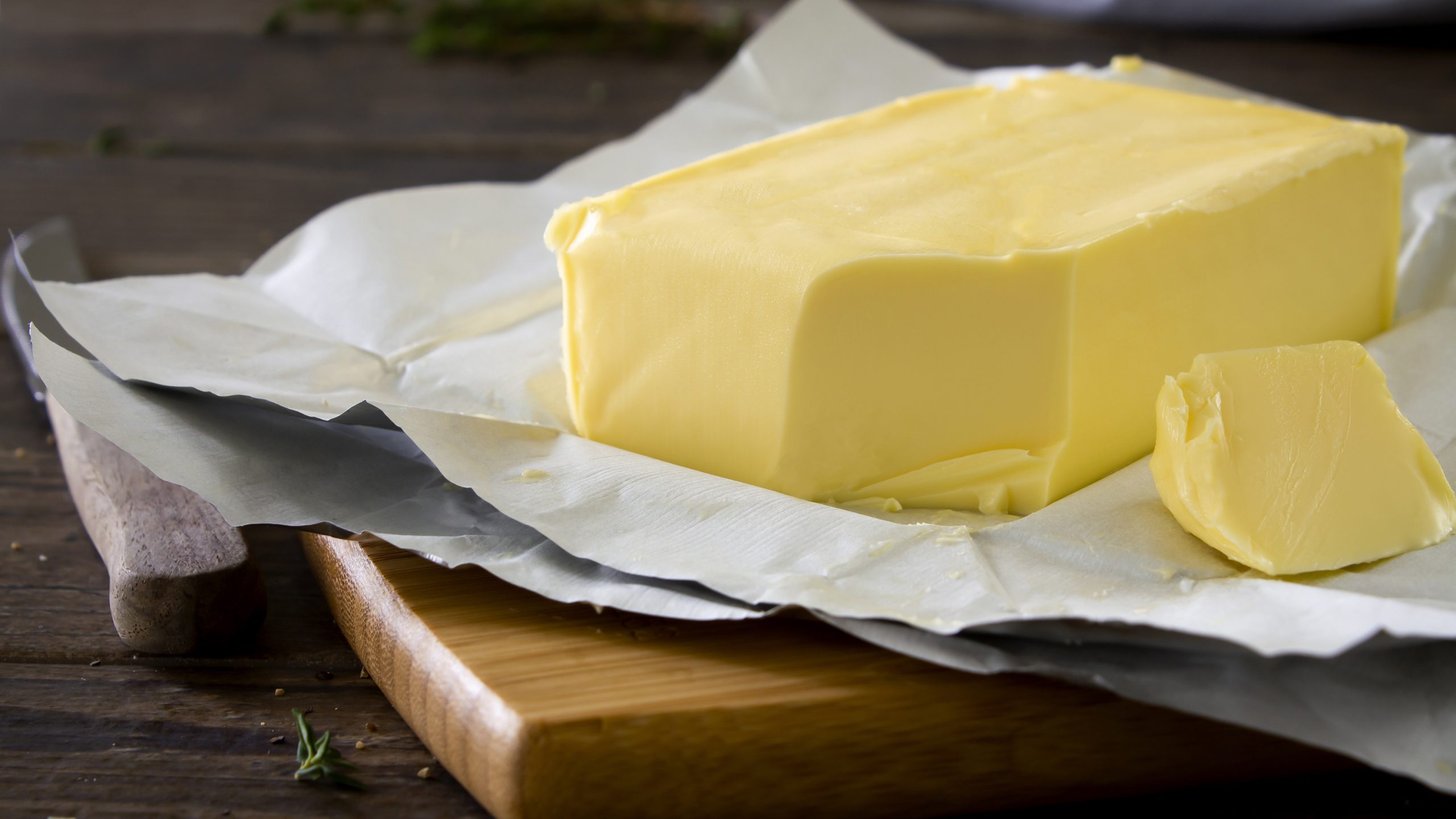 Butter sticks and a recall notice on a kitchen counter, symbolizing food safety concerns.